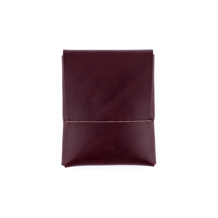 Folded maroon fabric on a white background