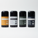Four black cylindrical containers with labels on a white background