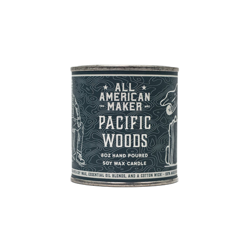 Candle container labeled 'All American Maker Pacific Woods' on a white background