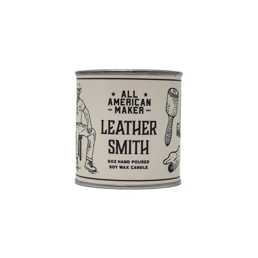 Candle container labeled 'All American Maker Leather Smith' on a white background