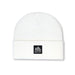 White beanie with a black logo patch on a white background