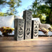 Decorative wooden blocks with Halloween designs on a wooden surface outdoors.