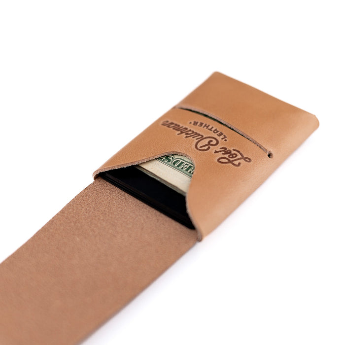 Brown leather money clip with brand name on a white background