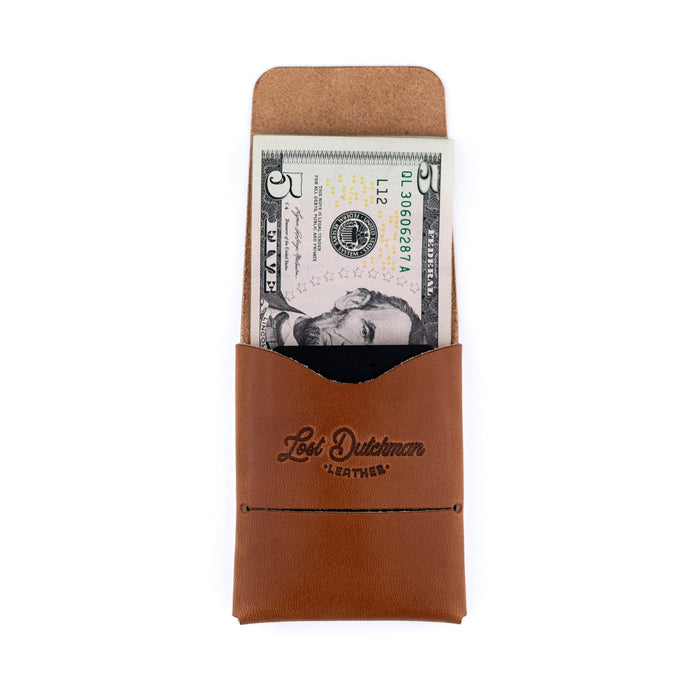 Brown leather wallet with a dollar bill inside on a white background