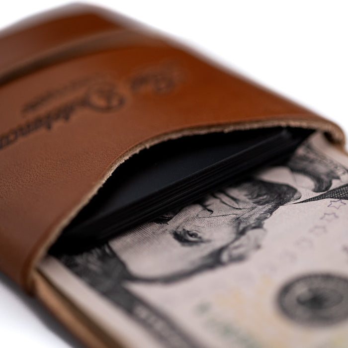 Brown leather wallet with money inside on a white background
