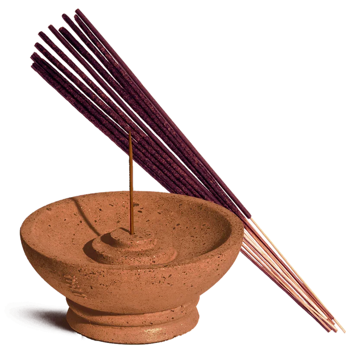 Terracotta incense burner with a single incense stick and purple incense sticks on a white background