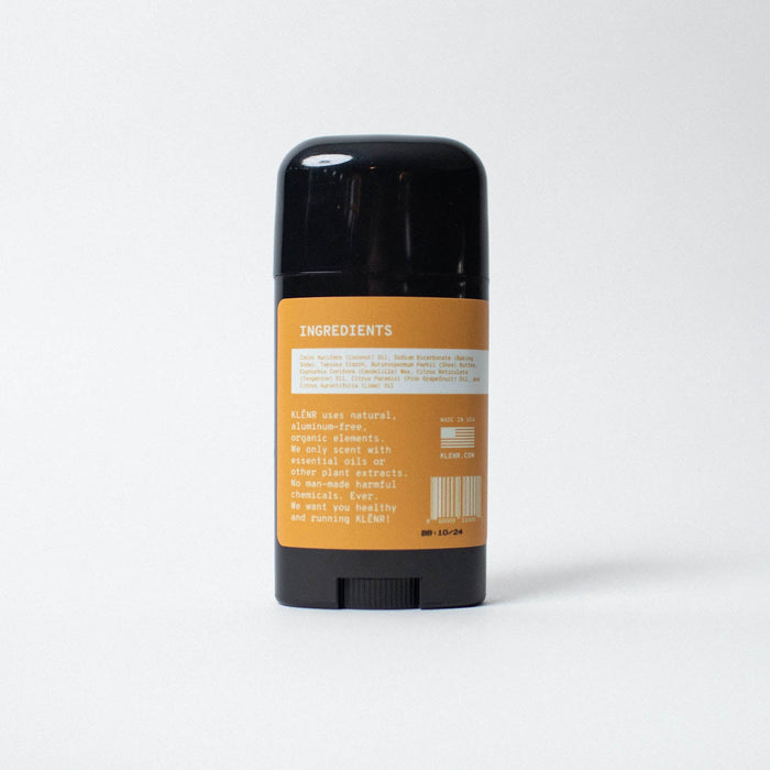 Deodorant stick with an orange label on a white background