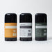 Three black cylindrical containers with labeled sides on a white background