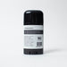 Black deodorant stick with a white label on a light gray background