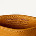 Close-up of brown leather with 'Real Leather Creations' text on a white background