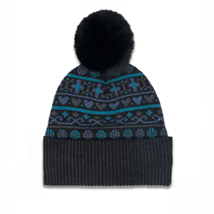 Knitted beanie with patterned top and black pom-pom on a white background