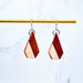Wooden geometric earrings on a marble background