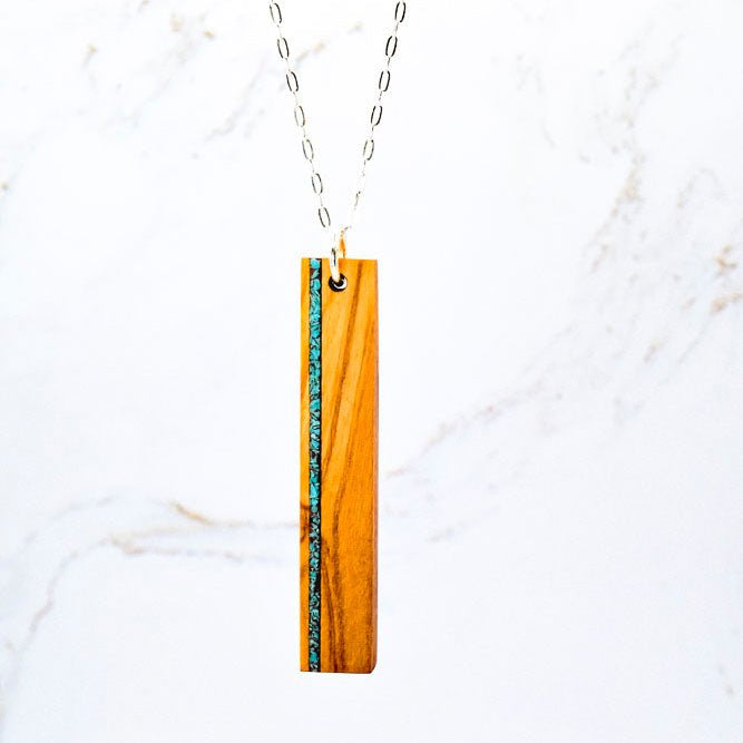 Necklace with a rectangular pendant on a white marble background
