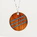 Necklace with a wooden pendant featuring blue stripes on a white background