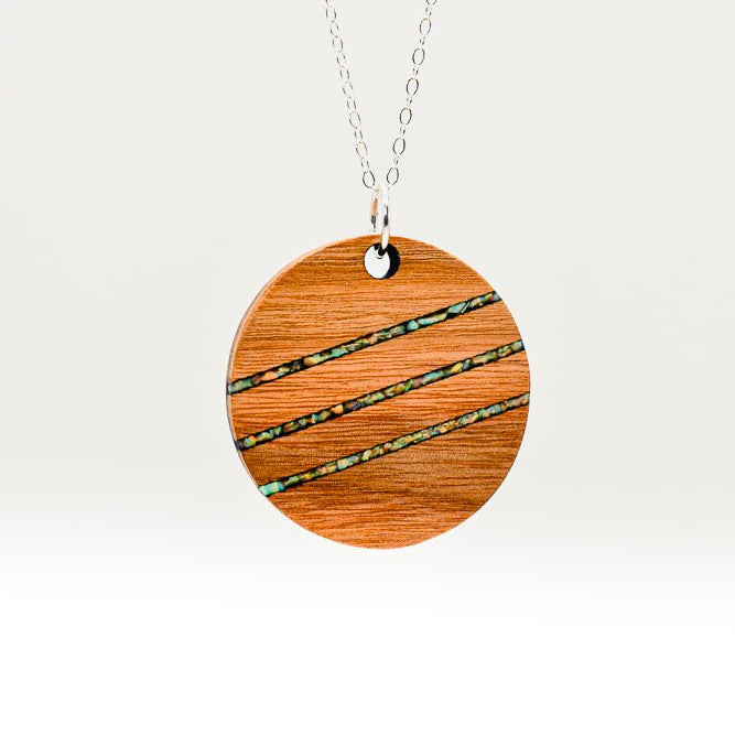 Wooden pendant necklace with a chain on a white background