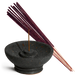 Black incense burner with a single incense stick and purple incense sticks on a white background