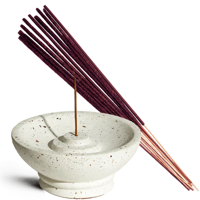 Incense sticks with a ceramic incense holder on a white background