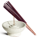 Incense sticks with a ceramic incense holder on a white background