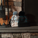 Two knit hats on a stone fireplace mantle.